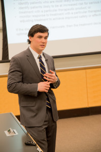 Ross School of Business student standing in front of projector screen during his presentation.