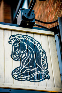 Close-up of Knight's Restaurant's horse head logo on wooden sign.